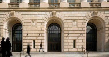 People walk by the Internal Revenue Service building