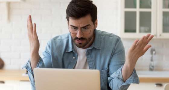 Man looking shocked at computer