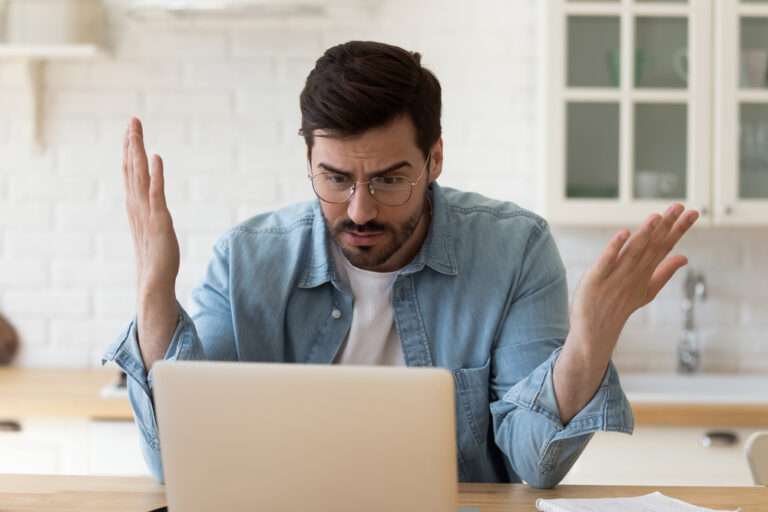 Man looking shocked at computer